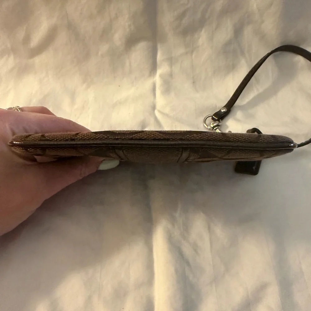 Coach Signature C canvas wristlet.